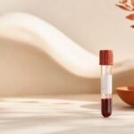 A single blood sample tube on a warm-toned surface