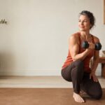 Woman strength training with a dumbbell in a calm, warm-toned room